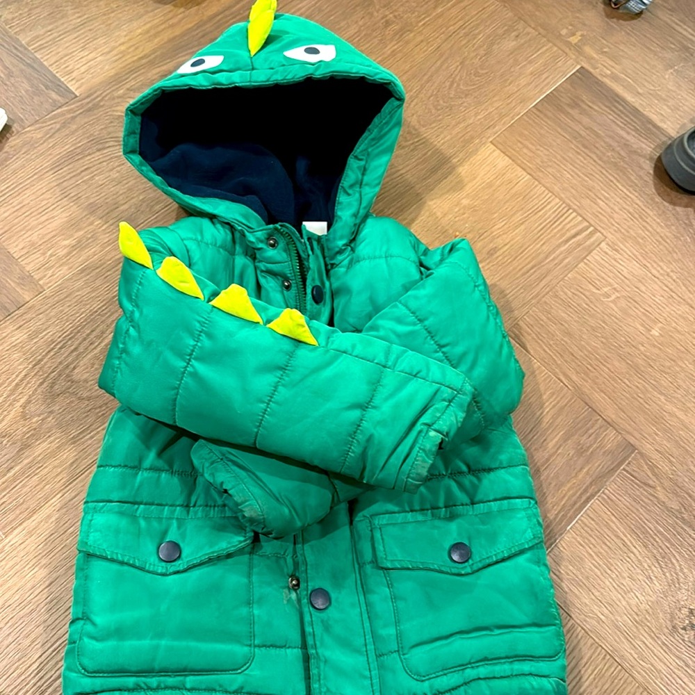 Adorable dinosaur puffer jacket w/ buttons &zipper. Thick blue underlining.
